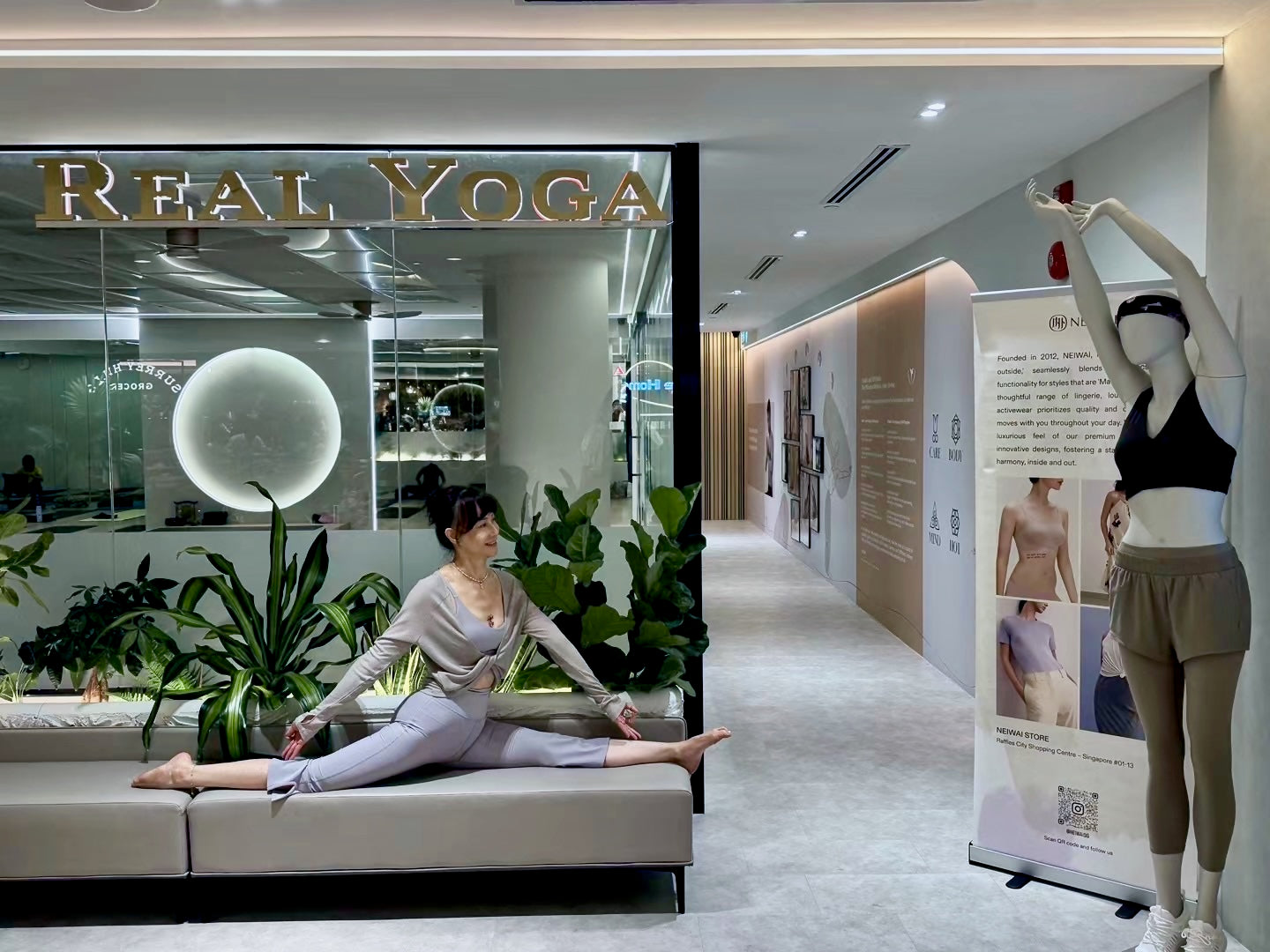 yoga instructor wearing neiwai outfit posing in front of real yoga raffles city branch