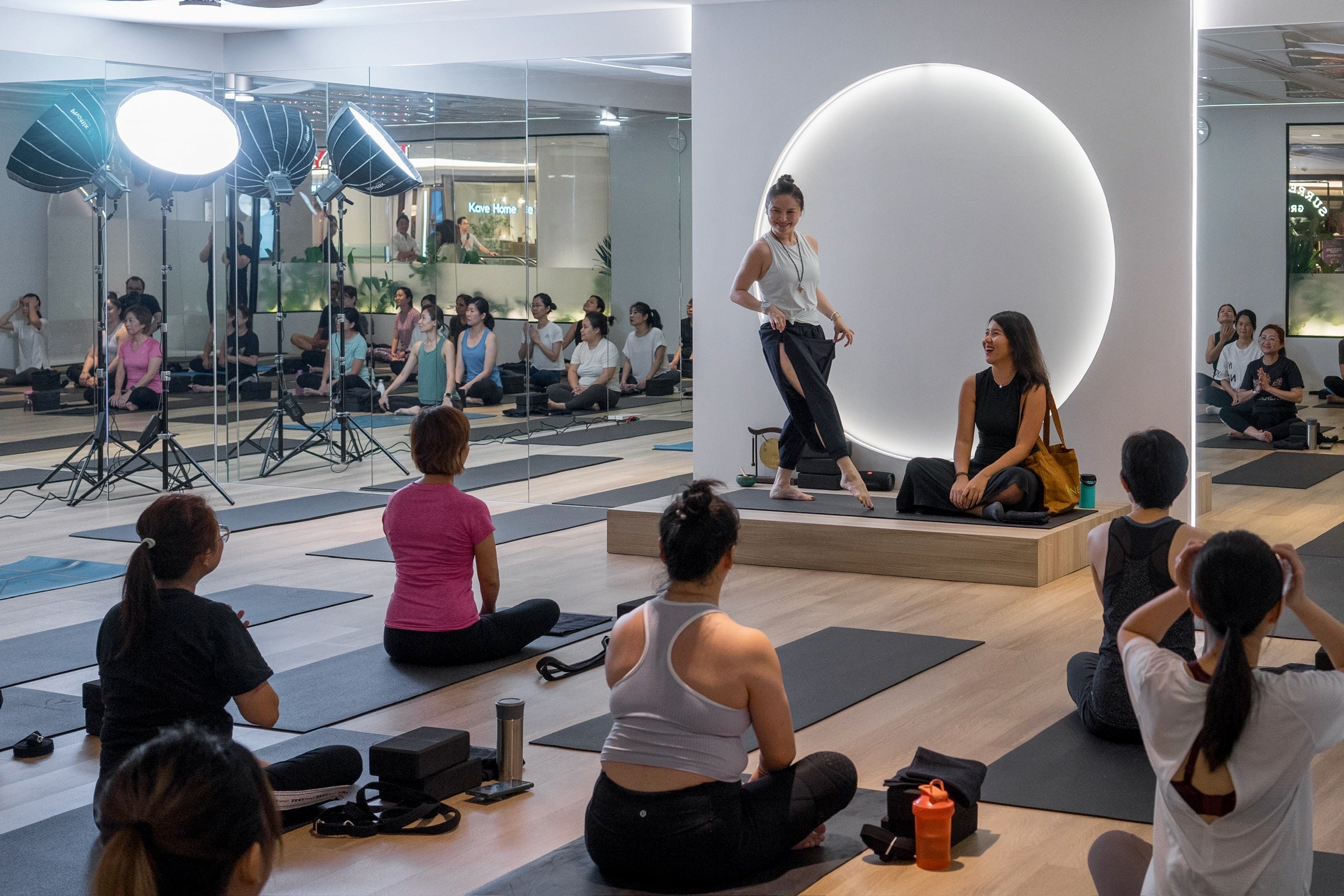 yoga instructor in neiwai outfit giving welcome speech